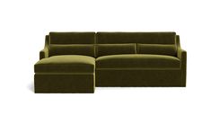 a large green couch sitting next to a footstool on top of a white floor