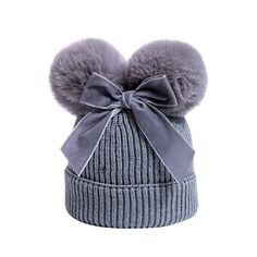 a gray hat with two pom poms on the top and a grey bow