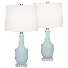 two light blue vases with white lamps on each lamp are both turned on and off