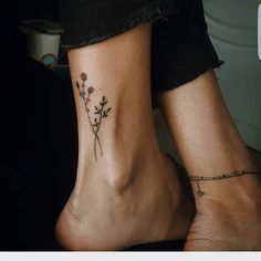 two people with tattoos on their feet and one has a flower tattoo on the ankle