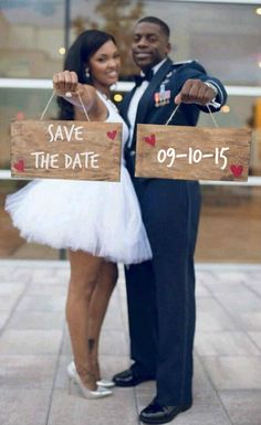 a man and woman holding signs that say save the date