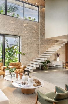 a living room filled with furniture next to a staircase