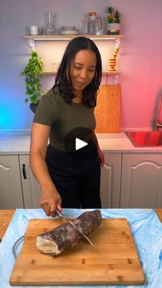 a woman cutting up food on top of a wooden cutting board