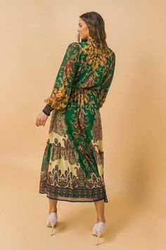 This is a beautiful brand new printed woven midi dress. It features a ruffled neckline with a tie/tassel. It has a peasant sleeve with smocked cuff, elasticized waist with sash tie, and ruffled hemline. It is made of 100% polyester, and the lining is also made of 100% polyester. Our model is 5'8" and wearing a size small. This item should be hand washed. Ships immediately to US addresses.