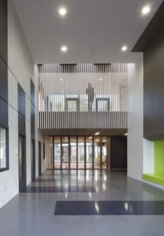 the inside of a large building with lots of windows and wood slats on the ceiling