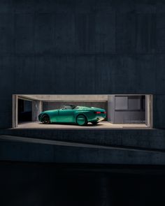 a green car is parked in a garage