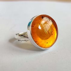 Welcome to our shop, Benefits of Amber Ring , Amber stone is considered a great natural purifier for its ability to absorb negative energy and vibrations from the body. It is also used for stimulating regeneration and healing of the soft tissue, detoxification, heart problems, arthritis, headache, and pain. Thanks for visiting my shop, Nature-inspired Sterling Silver Cabochon Ring, Spiritual Citrine Round Rings, Spiritual Round Citrine Rings, Spiritual Citrine Rings, Adjustable Round Crystal Ring With Natural Inclusions, Amber Crystal Round Ring, Amber Crystal Ring With Gemstone, Natural Stones Citrine Rings, Amber Crystal Sterling Silver Ring