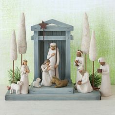 a nativity scene with figurines of people and animals in front of a small shrine