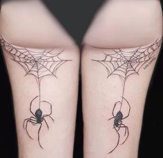 two legs with spider web tattoos on them