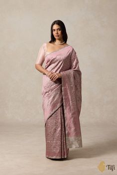 "An exceptional Katan silk Shikaargah saree crafted entirely in resham threadwork. With a melange of flora and fauna motifs and a minimal yet exquisitely patterned pallu, this is an artistic and understated take on a heritage handloom tradition.\n\n\n\n Color\u00a0- A shade of Grey with Pink resham weave\n\n\n Fabric\u00a0- Soft as butter, pure Katan silk\n\nTechnique\u00a0-\u00a0Classic handwoven Banarasi art passed down through generations of weavers.\n\n\n Speciality - A luxurious colour, an elaborate resham jaal and incredibly detailed animal motifs.\u00a0\n\n Tilfi Promise\u00a0- Pure. Handloom. Banaras.\n\nNote\u00a0- The saree comes with its own blouse piece. The model is wearing a separate blouse for styling purposes.\n\n\n\nSince this product is handwoven, there might be slight ir Elegant Katan Silk Saree With Chikankari Embroidery, Elegant Katan Silk Traditional Wear With Chikankari Embroidery, Luxury Art Silk Saree, Luxury Art Silk Saree In Traditional Drape, Raw Silk Saree With Woven Motifs For Wedding, Luxury Saree With Pallu Detail, Luxury Silk Saree With Traditional Drape, Luxury Silk Saree For Diwali, Luxury Banarasi Silk Saree For Festive Occasions