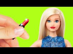 a barbie doll holding a red pen in her hand