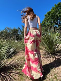 Step into a soft dreamscape of color with our Summer Tie-Dye Wide-Leg Pants. The perfect choice of vacation wear, these flared pants reflect free-spirited chic, letting you float through summer in unconfined comfort. Handcrafted from 100% Rayon, they offer exceptional breathability and a fluidic drape that keeps you cool and light as air all summer. It features an elasticated drawstring waist that offers an adjustable fit and side pockets for a practical flair. The vibrant tie-dye patterns captu Summer Maxi Length Bottoms For Day Out, Summer Festival Wide-leg Harem Pants, Bohemian Maxi Beach Bottoms, Bohemian Maxi-length Beach Bottoms, Bohemian Harem Pants For Beach Season, Bohemian Maxi Bottoms For Beach Season, Pink Bohemian Maxi Bottoms, Pink Bohemian Maxi Length Bottoms, Bohemian Pink Maxi Bottoms