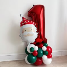 a number one balloon with a santa clause on it and some balloons in the shape of balls