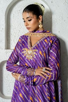 Purple anarkali featuring diagonal stripe print all over and floral, gota work detailing on the neckline. Paired with a pant and a lace border embellished scalloped dupatta. Comes with an inner and a potli bag. - Aza Fashions Designer Anarkali Sharara With Dabka Work, Anarkali Sharara With Dabka Work For Designer Wear, Semi-stitched Chanderi Sharara With Dabka, Festive Anarkali Style Unstitched Sharara, Festive Anarkali Sharara Unstitched, Anarkali Multicolor Kurta With Dabka Detail, Anarkali Multicolor Kurta With Dabka, Designer Anarkali Set In Mulmul, Purple Floor-length Kurta With Dabka Work