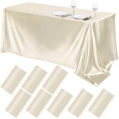 a table covered with white cloth and place settings