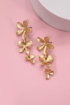 Beautiful earrings that make a statement! Perfect for your next vacation! Matte finish lightweight 2" long Summer Flower Shaped Metal Earrings, Chic Metal Flower Earrings For Spring, Spring Vacation Dangle Jewelry, Flower Shaped Earrings For Spring Vacation, Gold Earrings For Beach Spring Season, Flower-shaped Earrings For Spring Vacation, Flower-shaped Earrings For Vacation In Spring, Elegant Earrings For Vacation In Spring, Spring Vacation Flower Earrings