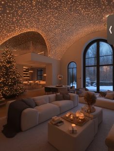 a living room filled with furniture and a christmas tree in the middle of the room