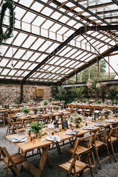 an indoor wedding venue with wooden tables and chairs set up for a formal dinner or party