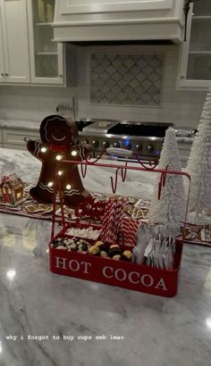 two trays filled with christmas treats on top of a kitchen counter next to an oven