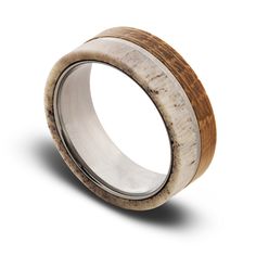 a wedding ring made out of wood and silver in the shape of an elephant's eye