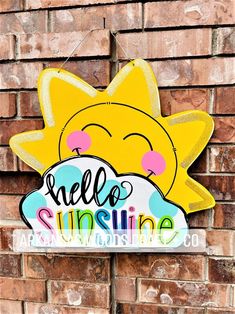 a hello sunshine sign hanging on the side of a brick wall