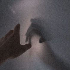 two hands reaching towards each other in the foggy sky with their fingers extended up