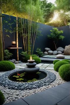 an outdoor garden with rocks, grass and water features in the center surrounded by bamboo trees