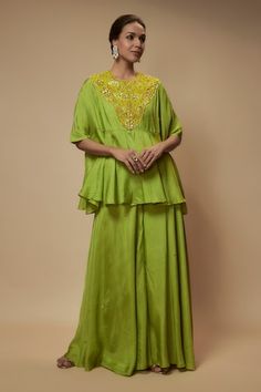 Green peplum tunic embellished by sequin bead floral motifs on yoke. Comes with sequined palazzo and slip - Aza Fashions Sequin Tunic, Green Tunic, Tunic Pattern, Floral Peplum, Cape Sleeves, Beaded Neckline, Indian Fashion Dresses, Sequin Beading, Floral Motifs