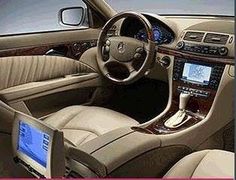 the interior of a car with beige leather and wood trim