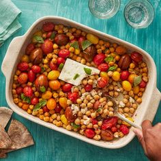 a casserole dish filled with chickpeas and tomatoes