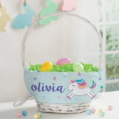 an easter basket filled with eggs and colorful candies on top of a white table