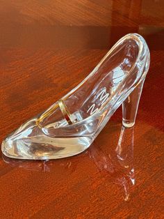 a pair of clear shoes sitting on top of a wooden table