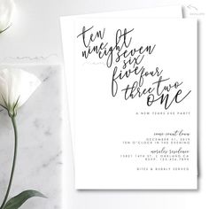 the wedding stationery is shown with calligraphy in black and white, along with flowers