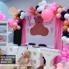 there is a teddy bear sitting in front of balloons