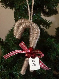 a christmas ornament hanging from the top of a tree with a red bow