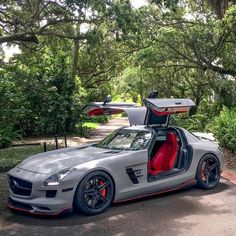 a silver sports car with its doors open