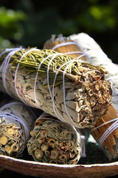 an assortment of rolled up herbs in a bowl