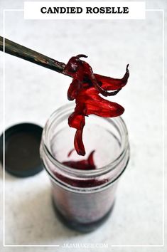 a jar filled with red liquid sitting on top of a table