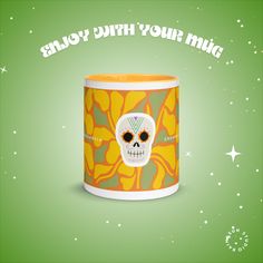 an orange and green mug with a skull on it