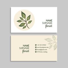 two business cards with green leaves on the front and back, both in white and beige