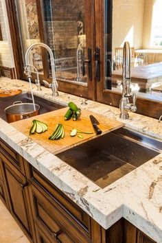 a kitchen sink with cutting board and knife on it