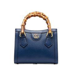 This stunning Gucci Diana shoulder bag features a blue leather body with bamboo handles, a detachable flat leather strap, gold-tone details and an additional Sylvie Web shoulder strap. The top is finished with a magnetic closure. The Bag can be over the arm or over the shoulder. Gucci Diana, Gucci Mini, Mini Blue, Gucci Bamboo, Mini Tote Bag, Bamboo Handles, Mini Tote, Vuitton Bag, Bags Designer Fashion