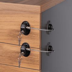 a close up of a wooden drawer with metal handles