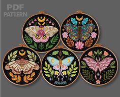 four embroidered hoops with butterflies and flowers on them, each decorated in different colors