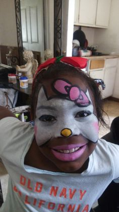 a girl with her face painted like a clown