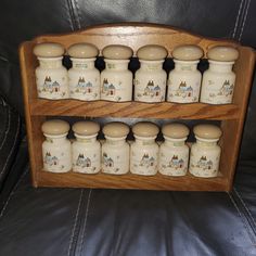 a wooden shelf filled with salt and pepper shakers on top of a leather couch