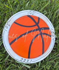 an orange and black basketball on the grass