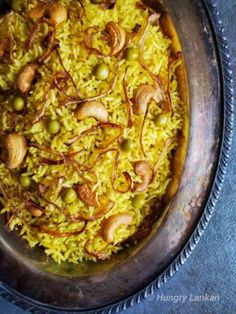 a bowl filled with rice and nuts on top of a table