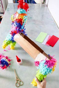 someone is doing something that looks like a baseball bat with colorful streamers on it