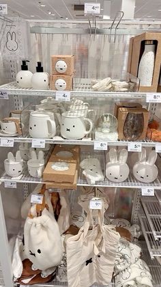 there are many items on the shelves in this store, including mugs and saucers